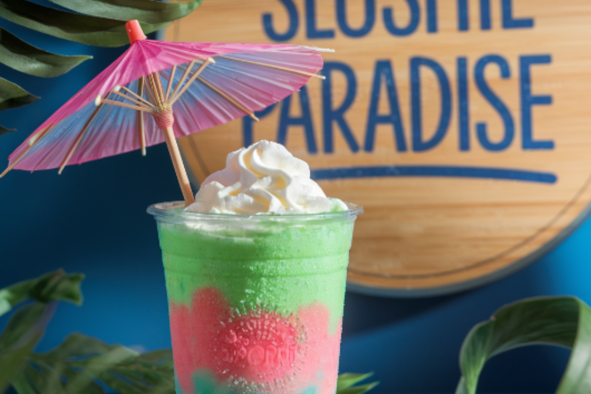 Refreshing slushie with vibrant colors, topped with a straw, perfect for a hot summer day.