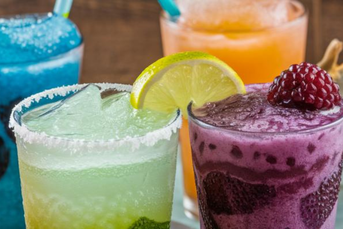 A variety of colorful Sonic slushies in different flavors, served in Sonic Drive-In cups.