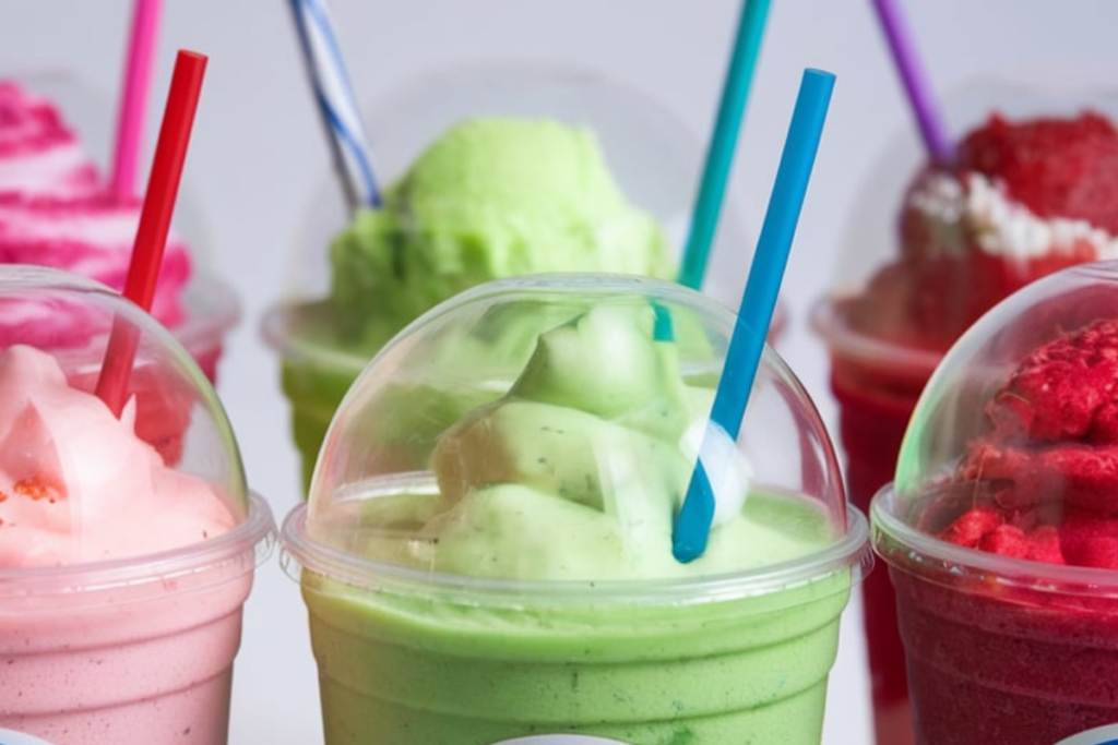 A variety of colorful Sonic slushies in different flavors, served in Sonic Drive-In cups.