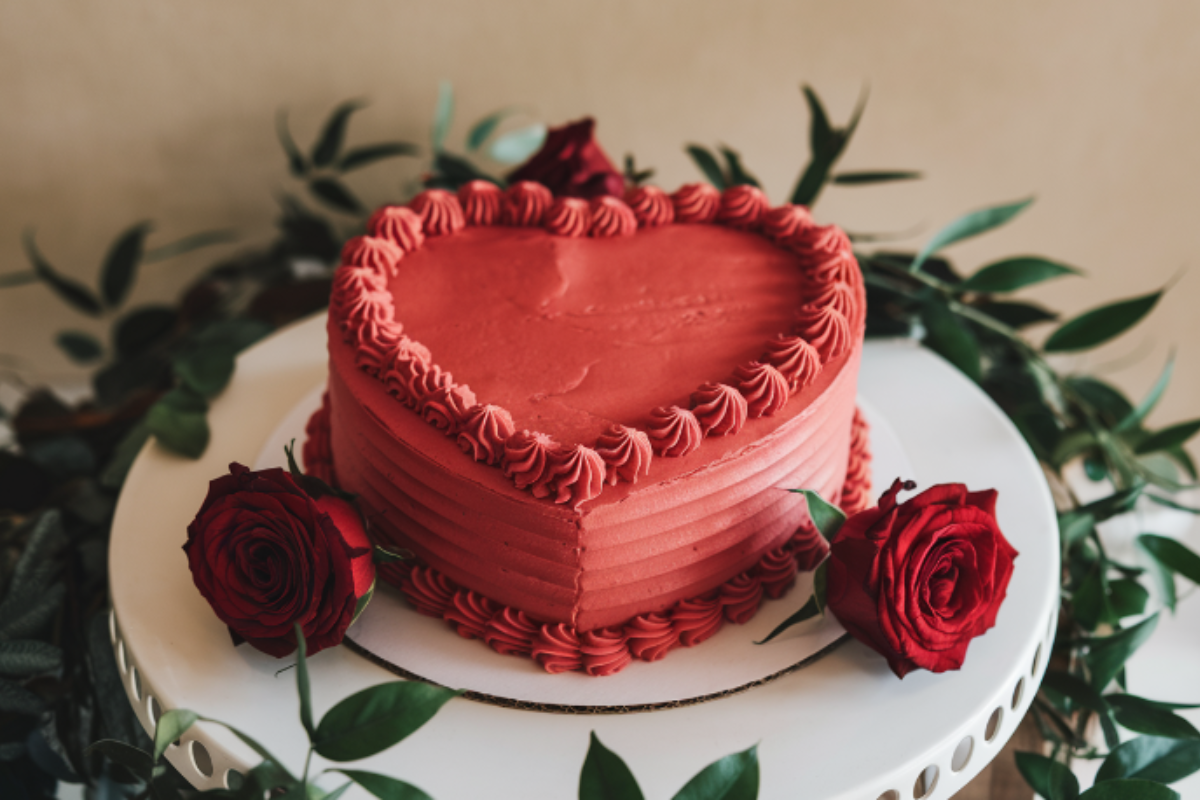 Heart-shaped cake with red frosting and decorations